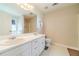 Bathroom with a double sink vanity, toilet, and large mirror at 704 Stonecrest Ln, Loganville, GA 30052