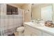 Cozy bathroom with white vanity, toilet, tub and striped shower curtain for a clean, functional space at 704 Stonecrest Ln, Loganville, GA 30052