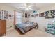 Bedroom featuring a ceiling fan, a twin bed, carpet flooring, and various artwork at 704 Stonecrest Ln, Loganville, GA 30052