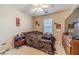 Comfortable bedroom with ceiling fan, dresser and natural light creating a cozy relaxing space at 704 Stonecrest Ln, Loganville, GA 30052