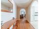 Hallway featuring hardwood floors and arched doorways leading to the living room and kitchen at 704 Stonecrest Ln, Loganville, GA 30052