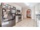 Kitchen featuring stainless steel appliances, white cabinets, and a tile floor; ready for culinary adventures at 704 Stonecrest Ln, Loganville, GA 30052