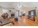 Bright living room with fireplace, hardwood floors, and seamless flow into the adjacent office space at 704 Stonecrest Ln, Loganville, GA 30052