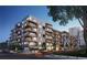 Exterior view showcasing a modern apartment building with multiple balconies and street-level activity at 775 Juniper St # 405, Atlanta, GA 30308