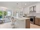Modern kitchen featuring an island with bar seating that flows into a living room with large windows and great views at 775 Juniper St # 405, Atlanta, GA 30308