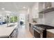 Contemporary kitchen featuring stainless steel appliances, quartz countertops, and a seamless flow into the living space at 775 Juniper St # 405, Atlanta, GA 30308