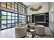 Bright and spacious resident lounge featuring modern furnishings, and a large glass wall with city views at 775 Juniper St # 405, Atlanta, GA 30308