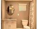 Traditional bathroom featuring a vanity with granite countertop, oval mirror and shower with patterned curtain at 836 Wood Nw St, Atlanta, GA 30318