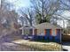 Charming blue bungalow featuring a covered porch and a fenced front yard at 836 Wood Nw St, Atlanta, GA 30318