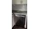 Stainless steel dishwasher in a modern kitchen with granite countertops and white cabinets at 836 Wood Nw St, Atlanta, GA 30318