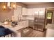 Bright kitchen with white cabinetry, stainless steel appliances, granite countertops and pendant lights at 836 Wood Nw St, Atlanta, GA 30318
