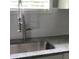 Modern kitchen sink with stainless steel faucet, granite countertops and tile backsplash at 836 Wood Nw St, Atlanta, GA 30318