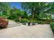 Beautiful backyard featuring a custom patio, seating area, lush landscaping, and string lights at 916 Stratford Rd, Avondale Estates, GA 30002
