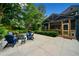 Wonderful backyard with a custom patio, seating around a firepit, lush landscaping, and string lights at 916 Stratford Rd, Avondale Estates, GA 30002