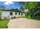 Spacious backyard with a basketball court, grassy area, and a view of the home's exterior at 916 Stratford Rd, Avondale Estates, GA 30002