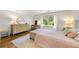 Bright bedroom with neutral tones, hardwood floors, and large window overlooking landscaped backyard at 916 Stratford Rd, Avondale Estates, GA 30002