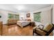 Bedroom with hardwood floors, natural light, a cozy couch, and a comfortable seating area at 916 Stratford Rd, Avondale Estates, GA 30002