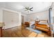 Cozy bedroom with two beds, a ceiling fan, and classic hardwood flooring at 916 Stratford Rd, Avondale Estates, GA 30002