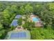 Beautiful aerial view features the community pool and tennis courts surrounded by green trees at 916 Stratford Rd, Avondale Estates, GA 30002