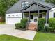 Inviting covered front porch with brick steps, updated lighting, and great curb appeal at 916 Stratford Rd, Avondale Estates, GA 30002