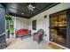 Relaxing front porch area with comfortable seating, ceiling fan, and modern door at 916 Stratford Rd, Avondale Estates, GA 30002
