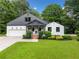 Charming home with manicured lawn, lush landscaping, and attached garage at 916 Stratford Rd, Avondale Estates, GA 30002