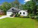 Charming home with manicured lawn, lush landscaping, and inviting entryway at 916 Stratford Rd, Avondale Estates, GA 30002