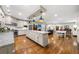 Open kitchen featuring a large center island, stainless steel appliances, and hardwood floors in an open floorplan at 916 Stratford Rd, Avondale Estates, GA 30002