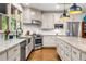 Bright kitchen features stainless appliances, granite countertops, white subway tile backsplash, and large windows at 916 Stratford Rd, Avondale Estates, GA 30002