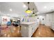 Spacious kitchen features a large island, stainless appliances, and hardwood floors that flow into the living area at 916 Stratford Rd, Avondale Estates, GA 30002