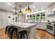 Well-lit kitchen featuring a granite island with seating, stainless steel appliances, and lots of cabinet space at 916 Stratford Rd, Avondale Estates, GA 30002