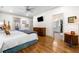 Inviting main bedroom with hardwood floors, ceiling fan, and access to the ensuite bathroom and exterior deck at 916 Stratford Rd, Avondale Estates, GA 30002