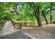 A tranquil scene featuring a bridge over a pond, surrounded by lush trees and greenery at 916 Stratford Rd, Avondale Estates, GA 30002