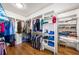 Spacious walk-in closet with custom shelving, hanging rods, and hardwood floors for organized storage at 916 Stratford Rd, Avondale Estates, GA 30002