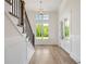 Bright entryway featuring hardwood floors, staircase and large windows at 002 Wakehurst Way, Marietta, GA 30064