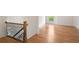 Hallway featuring stairs with metal railings, hardwood floors and a window at 002 Wakehurst Way, Marietta, GA 30064