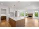 Open concept kitchen with a center island, white cabinets and view into a spacious living room at 002 Wakehurst Way, Marietta, GA 30064