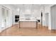 Modern kitchen with a large island, hardwood floors, and stainless steel appliances at 002 Wakehurst Way, Marietta, GA 30064