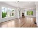 Spacious living room with large windows, hardwood floors and a brick fireplace at 002 Wakehurst Way, Marietta, GA 30064