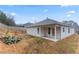 View of the backyard and patio, with a sloping hillside and tree line beyond at 10231 Deep Creek Pl, Union City, GA 30291
