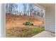 View of the backyard and patio, with a sloping hillside and tree line at 10231 Deep Creek Pl, Union City, GA 30291