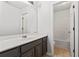 Bathroom features a long countertop with dark wood cabinets and a view of the bathtub at 10231 Deep Creek Pl, Union City, GA 30291