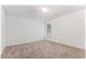 Spacious bedroom features neutral carpet, one window, and light neutral walls at 10231 Deep Creek Pl, Union City, GA 30291