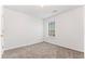 Bedroom features neutral carpet, one window, and light neutral walls at 10231 Deep Creek Pl, Union City, GA 30291