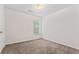 Bedroom features neutral carpet, one window, and light neutral walls and door access at 10231 Deep Creek Pl, Union City, GA 30291