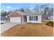 Well-maintained single-story house with a brick accent and a two-car garage at 10231 Deep Creek Pl, Union City, GA 30291