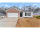 Charming single-story home with a brick facade and a two-car garage at 10231 Deep Creek Pl, Union City, GA 30291