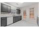 Stylish kitchen with gray cabinets, marble countertops, and modern fixtures at 10231 Deep Creek Pl, Union City, GA 30291