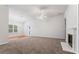 Open-concept living area with a fan and a decorative fireplace at 10231 Deep Creek Pl, Union City, GA 30291