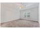 Inviting main bedroom with a large window and plush carpeting at 10231 Deep Creek Pl, Union City, GA 30291